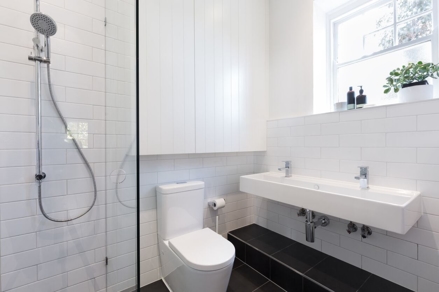 white bathroom with double sink and toilet