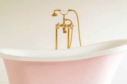 vintage pink bathtub with bronze faucet