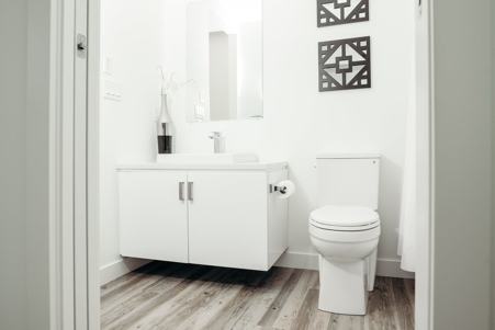white bathroom with vinyl plank flooring