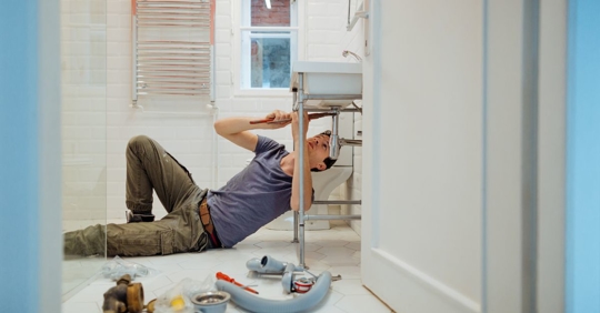man working on plumbing