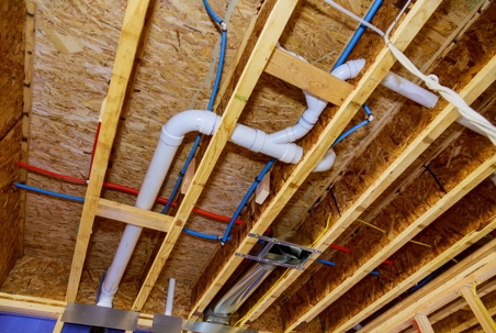 exposed pvc and and pex plumbing pipes