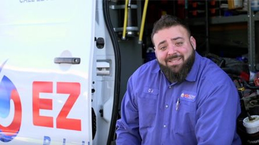 An employee sits in a van talking about his exeriences.