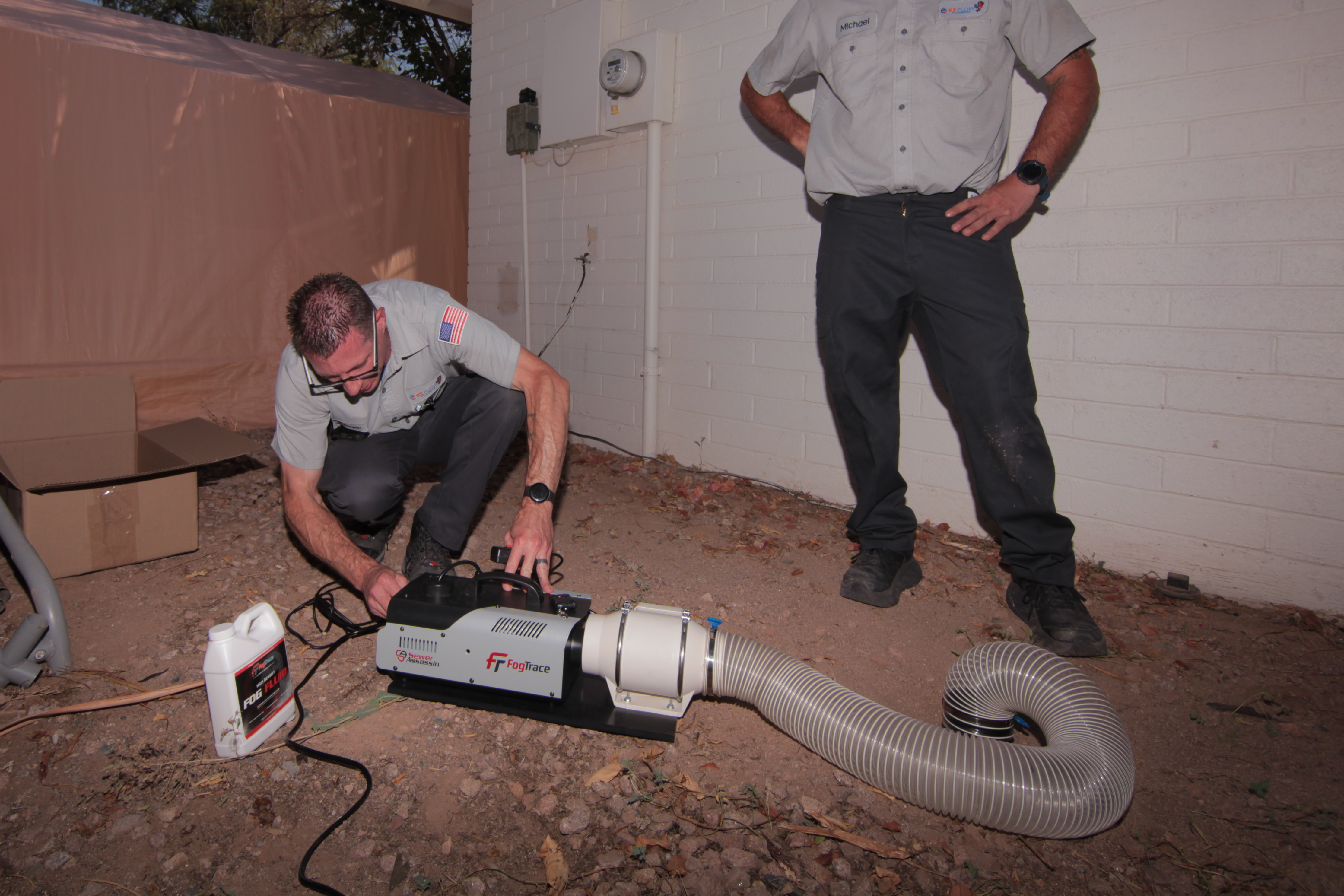 Two EZ Flow Plumbers setting up FogTrace Smoke Test