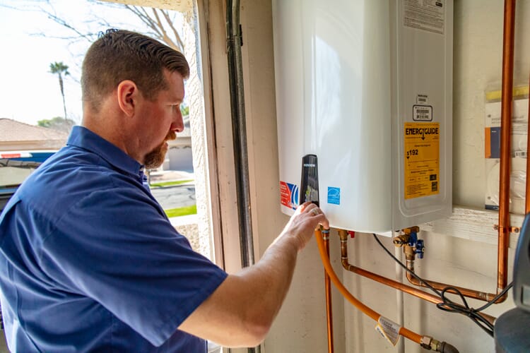 EZ Flow Plumbing technician working on a tankless water heater